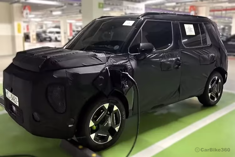 Kia Syros EV SUV Exterior view with charger Kia Syros EV SUV Exterior view with charger