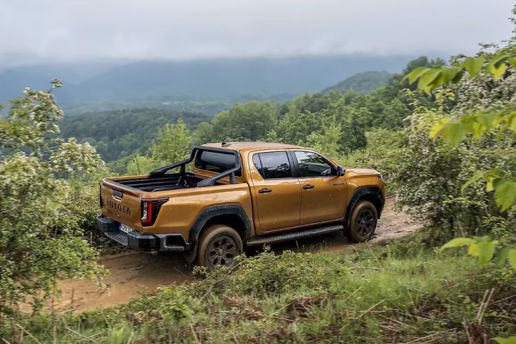 Toyota Hilux Right rear side exterior view in the offroading conditions Toyota Hilux Right rear side exterior view in the offroading conditions